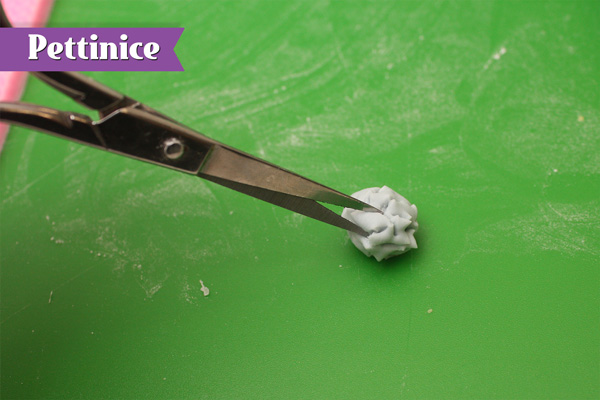 Take a small ball of blue and snip to make a pompom.