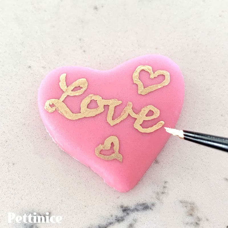 25. Now you can paint a short message or design on the heart or leave as is. I used a little gold dust mixed with alcohol and painted with a fine brush. An edible ink pen would work really well if you have one.