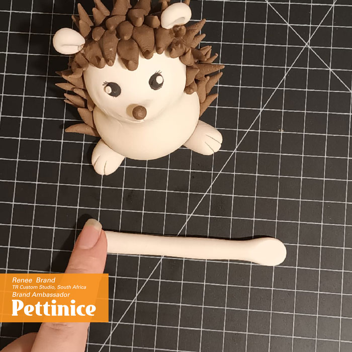 Flatten each end lightly with your finger to create your hands.